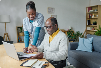 caregiver-helping-man-pay-bills